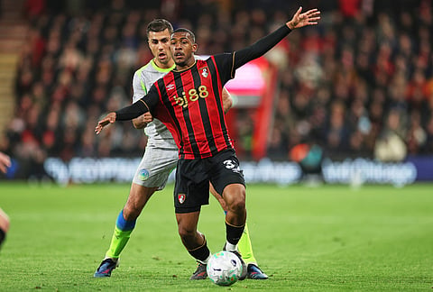Manchester City's Rodrigo, left, challenges for the ball with Bournemouth's Rayan during the English Premier League soccer match between AFC Bournemouth and Manchester City in Bournemouth, England.