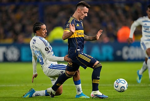 Malcom Braida of Argentina's Boca Juniors, right, and Christian of Brazil's Cruzeiro battle for the ball during a Copa Libertadores Group D soccer match in Buenos Aires, Argentina.