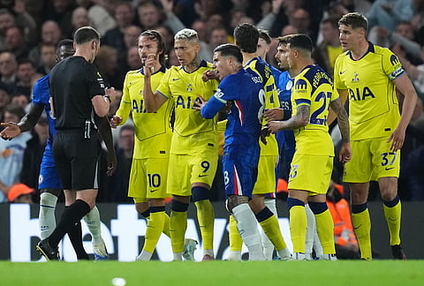 Players argue with a referee during a Premier League soccer match between Chelsea and Tottenham in London.