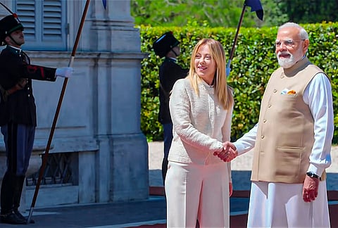 Prime Minister Narendra Modi, right, exchanges a handshake with Italian Prime Minister Giorgia Meloni, in Italy.