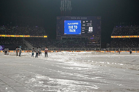 Ground staff cover the pitch due to rain during the Indian Premier League (IPL) 2026 T20 cricket match between Kolkata Knight Riders and Mumbai Indians, in Kolkata, West Bengal.