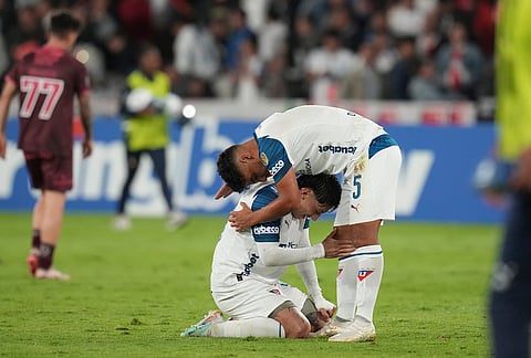 Players of Ecuador's Liga Deportiva Universitaria react at the end of Copa Libertadores Group G soccer match against Argentina's Lanus in Quito, Ecuador.