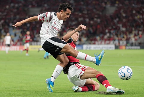 Tiago Palacios of Argentina's Estudiantes de La Plata, left, and Ayrton Lucas of Brazil's Flamengo battle for the ball during a Copa Libertadores Group A soccer match in Rio de Janeiro.