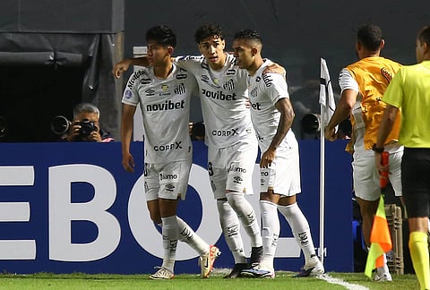 Gabriel Bontempo of Brazil's Santos, center, celebrates with teammates after scoring his side's opening goal against Argentina's San Lorenzo during a Copa Sudamericana Group D soccer match in Santos, Brazil.