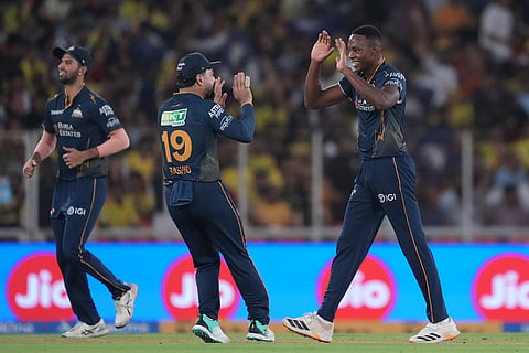 Gujarat Titans' Kagiso Rabada, right, celebrates the wicket of Chennai Super Kings' Matthew Short with teammates during the Indian Premier League cricket match between Gujarat Titans and Chennai Super Kings in Ahmedabad, India.