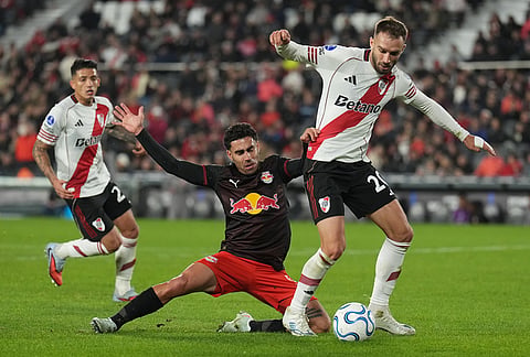 Gabriel Girotto of Brazil's Red Bull Bragantino, center, and German Pezzella of Argentina's River Plate battle for the ball during a Copa Sudamericana Group H soccer match in Buenos Aires, Argentina.