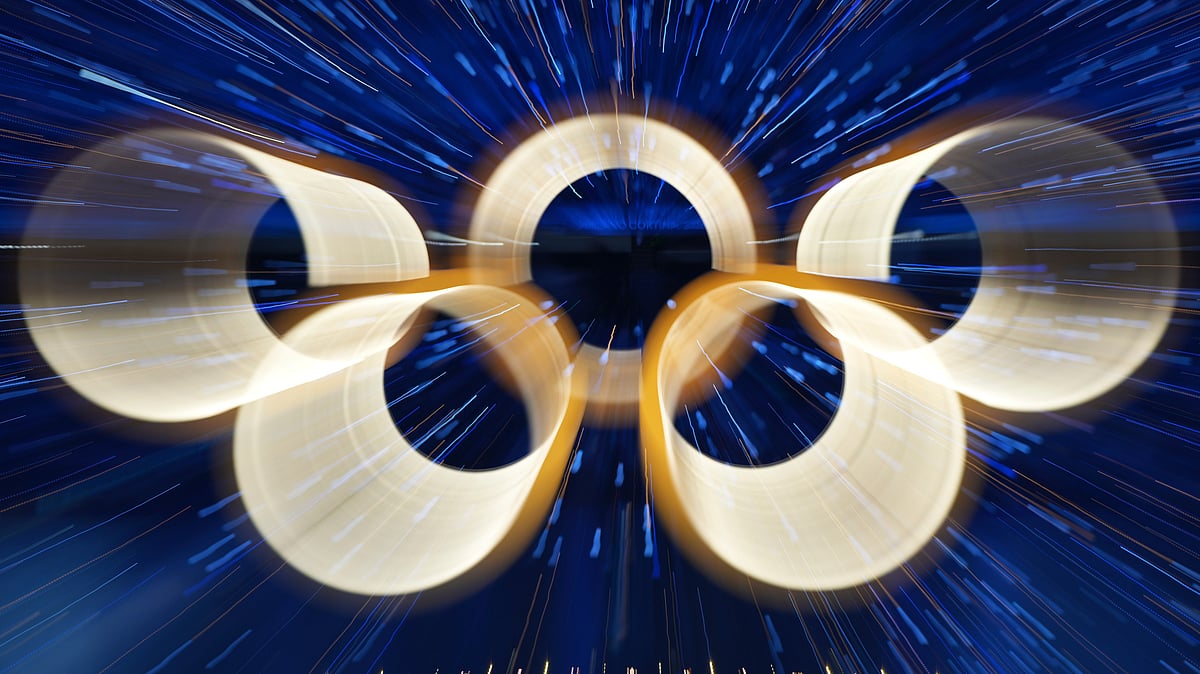 FILE - The Olympic rings are illuminated during the Olympic opening ceremony at the 2026 Winter Olympics, in Milan, Italy, Friday, Feb. 6, 2026 - (AP Photo/Francisco Seco, File)