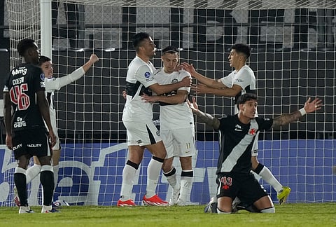 Carlos Ferreira of Paraguay's Olimpia, center, celebrates with teammates after scoring his side's third goal against Brazil's Vasco da Gama during a Copa Sudamericana Group G soccer match in Asuncion, Paraguay.