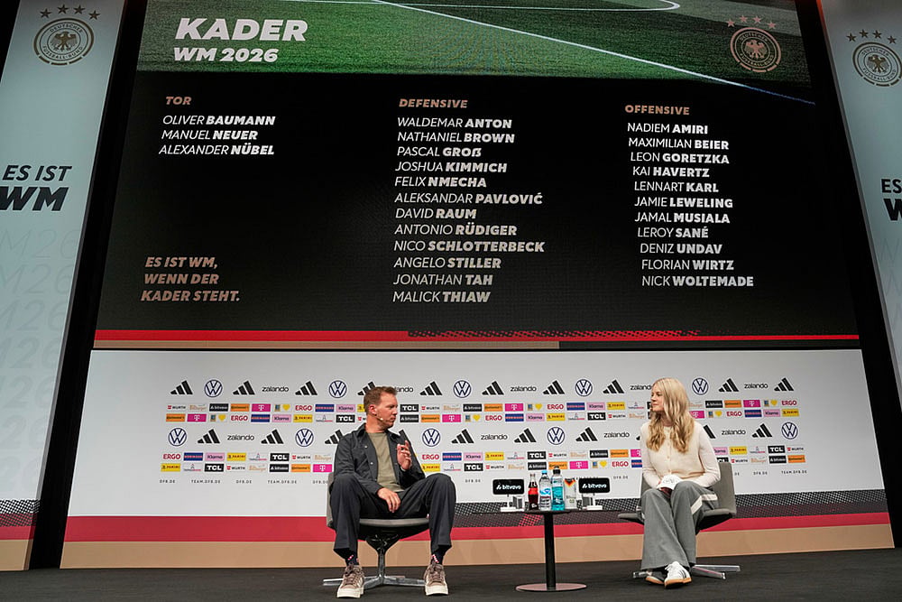Germany's head coach Julian Nagelsmann, left, speaks with DFB media spokeswoman Franziska Wuelle as he announces the squad for the 2026 FIFA World Cup during a news conference at the German Football Association, DFB, headquarters in Frankfurt, Germany. - | Photo: AP/Michael Probst