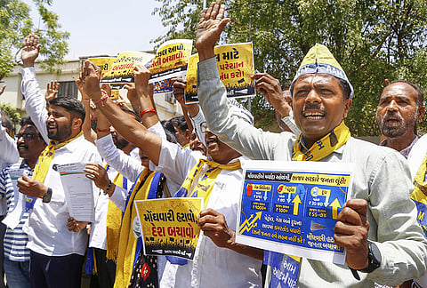 AAP workers stage a protest against the hike in fuel prices and rising inflation of essential commodities, outside collector office, in Ahmedabad, Gujarat.
