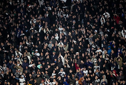 Fans of Paraguay's Olimpia cheer their team on from the stands during a Copa Sudamericana Group G soccer match against Paraguay's Olimpia in Asuncion, Paraguay.
