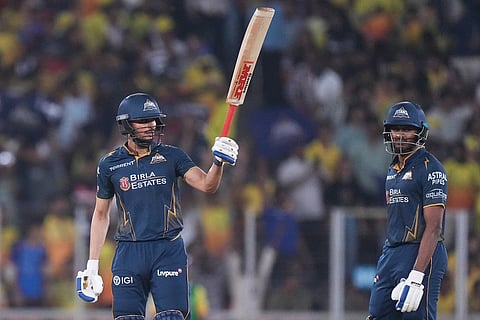 Gujarat Titans' captain Shubman Gill celebrates his fifty runs as Sai Sudharsan watches during the Indian Premier League cricket match between Gujarat Titans and Chennai Super Kings in Ahmedabad, India.