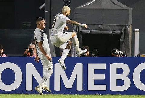 Gabriel Barbosa of Brazil's Santos, right, celebrates scoring his side's second goal against Argentina's San Lorenzo during a Copa Sudamericana Group D soccer match in Santos, Brazil.