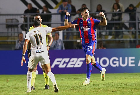 Rodrigo Auzmendi of Argentina's San Lorenzo, right, celebrates scoring his side's second goal against Brazil's Santos during a Copa Sudamericana Group D soccer match in Santos, Brazil.