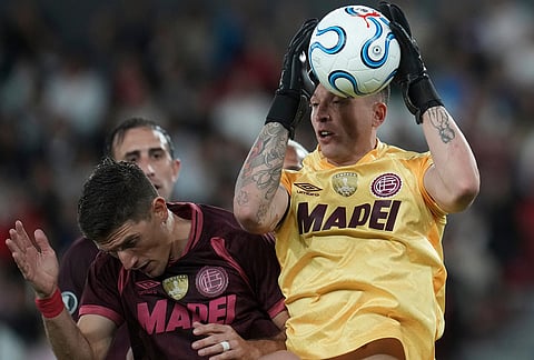 Goalkeeper Nahuel Losada of Argentina's Lanus catches the ball during a Copa Libertadores Group G soccer match against Ecuador's Liga Deportiva Universitaria in Quito, Ecuador.