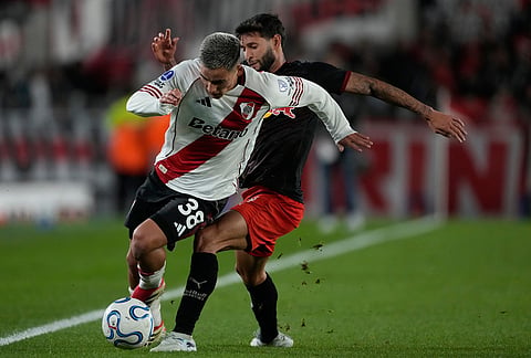 Juninho Capixaba of Brazil's Red Bull Bragantino, right, and Ian Subiabre of Argentina's River Plate battle for the ball during a Copa Sudamericana Group H soccer match in Buenos Aires, Argentina.