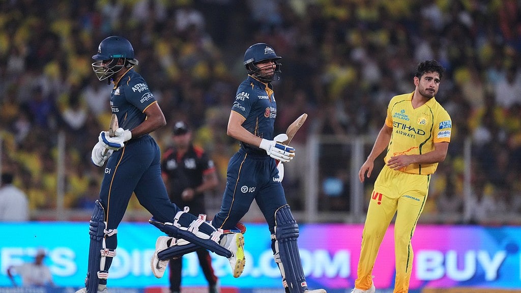 Chennai Super Kings' Mukesh Choudhary, right, watches as Gujarat Titans' captain Shubman Gill and Sai Sudharsan, left, run between the wickets during the Indian Premier League cricket match between Gujarat Titans and Chennai Super Kings in Ahmedabad, India, Thursday, May 21, 2026 - AP Photo/Ajit  Solanki