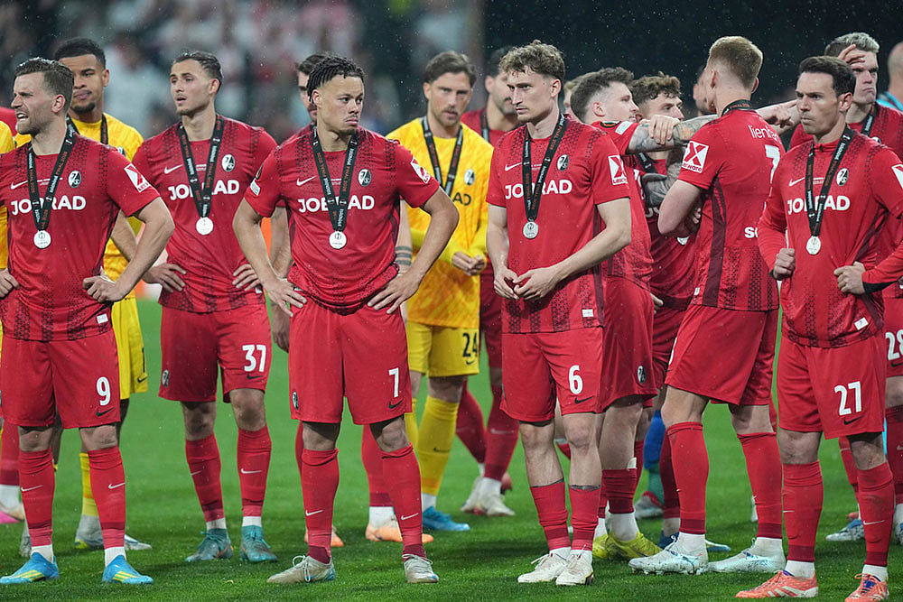 Freiburg players react after the Europa League final soccer match between Freiburg and Aston Villa in Istanbul, Turkey.