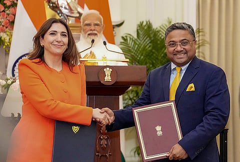 Prime Minister Narendra Modi looks on as External Affairs Ministry Spokesperson Randhir Jaiswal, right, exchanges an MoU with a Cypriot official during a joint press statement after delegation level talks at the Hyderabad House, in New Delhi.