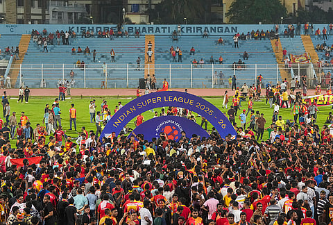 East Bengal supporters celebrate after their team’s victory in the Indian Super League (ISL) 2026 football match against Inter Kashi, in Kolkata.