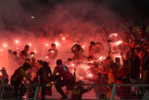 East Bengal supporters celebrate with flares after their team’s victory in the Indian Super League (ISL) 2026 football match against Inter Kashi, in Kolkata.
