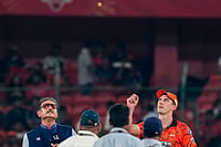 | Photo: PTI/Salman Ali : Sunrisers Hyderabad's captain Pat Cummins flips the coing as former cricketer and commentator Ravi Shastri looks on during toss ahead of the Indian Premier League (IPL) 2026 T20 cricket match between Sunrisers Hyderabad and Royal Challengers Bengaluru, in Hyderabad, Telangana.