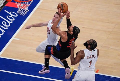 New York Knicks guard Josh Hart (3) is blocked by Cleveland Cavaliers guard Sam Merrill (5) during the second half of Game 2 in the Eastern Conference finals NBA basketball playoffs series, in New York.