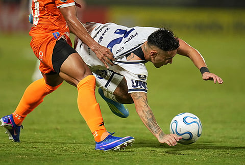 Matias Fernadez of Argentina's Independiente Rivadavia, right, and Jorge Gutierrez of Venezuela's Deportivo La Guaira battle for the ball during a Copa Libertadores Group C soccer match in Caracas, Venezuela.