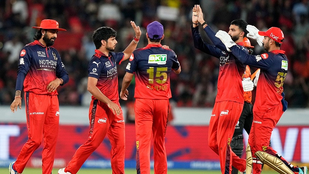 Royal Challengers Bengaluru's Rasikh Dar, second left, and others celebrate the wicket of Sunrisers Hyderabad's Travis Head during their Indian Premier League match in Hyderabad. - AP/Mahesh Kumar A.