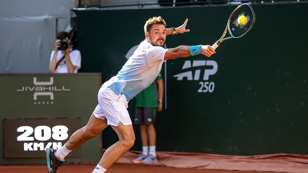 Stan Wawrinka, from Switzerland, returns a ball to Alex Michelsen, of the United States, during a round of 16 match at the Geneva Open tennis tournament in Geneva. - Martial Trezzini/Keystone via AP