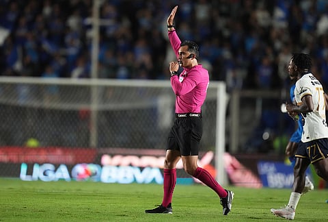 Referee Ismael Lopez cancels a penalty for Cruz Azul after reviewing the VAR during the Mexican soccer league first leg final match against Pumas in Mexico City.