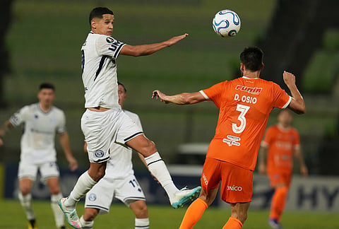 Alex Arce of Argentina's Independiente Rivadavia, left, and Diego Osio of Venezuela's Deportivo La Guaira battle for the ball during a Copa Libertadores Group C soccer match in Caracas, Venezuela.