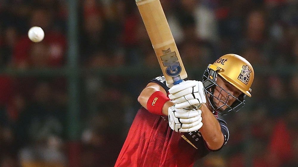 Royal Challengers Bengaluru's Jacob Bethell hits a boundary during the Indian Premier League cricket match between Royal Challengers Bengaluru and Gujarat Titans in Bengaluru. - | Photo: AP