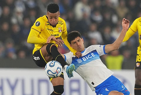 Byron Castillo of Ecuador's Barcelona, left, and Justo Giani of Chile's Universidad Catolica vie for the ball during a Copa Libertadores Group D soccer match in Santiago, Chile.