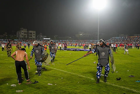 Security personnel disperse East Bengal supporters who invaded the field to celebrate their team’s victory in the Indian Super League (ISL) 2026 football match against Inter Kashi, in Kolkata.