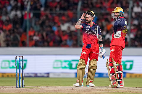Royal Challengers Bengaluru's Virat Kohli and Venkatesh Iyer, right, interact between the wickets during an Indian Premier League (IPL) 2026 T20 cricket match between Sunrisers Hyderabad and Royal Challengers Bengaluru, in Hyderabad, Telangana.
