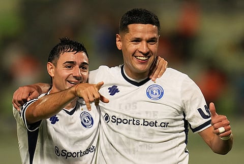 Alex Arce of Argentina's Independiente Rivadavia, right, celebrates with Tomas Bottari of Argentina's Independiente Rivadavia after scoring his side's third goal against Venezuela's Deportivo La Guaira during a Copa Libertadores Group C soccer match in Caracas, Venezuela.