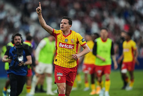 Lens' Florian Thauvin celebrates after scoring during the French Cup soccer final between Nice and Lens in Saint-Denis, outside Paris.