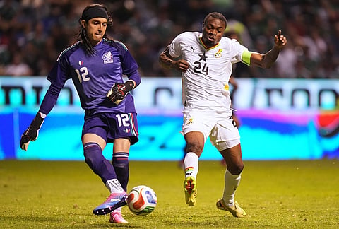 Mexico's goalkeeper Carlos Acevedo, left, is challenged by Ghana's Jerry Afriyie during an international friendly soccer match in Puebla, Mexico.