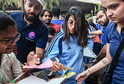 India women's Jemimah Rodrigues signs an autograph as she departs for the ICC Women’s World Cup 2026, in Mumbai, Maharashtra.
