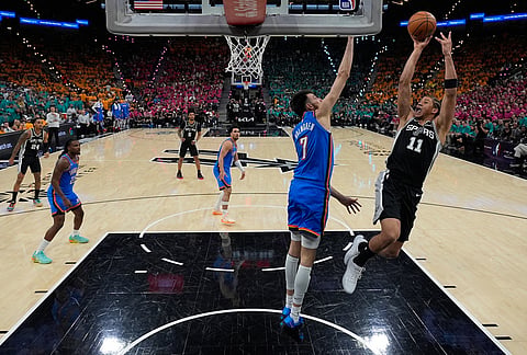 San Antonio Spurs forward Carter Bryant (11) shoots over Oklahoma City Thunder center Chet Holmgren (7) during the second half of Game 3 in the Western Conference finals NBA basketball playoffs series in San Antonio. 