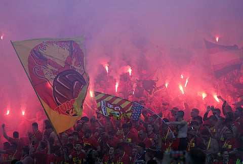 Lens' supporters wave their flags during the French Cup soccer final between Nice and Lens in Saint-Denis, outside Paris.