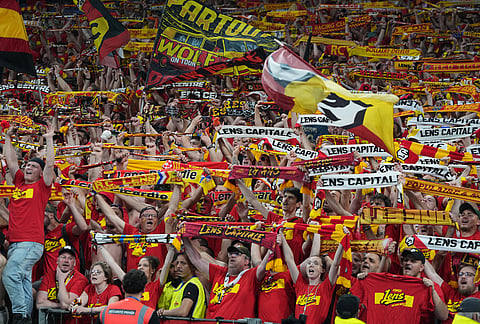 Lens' supporters celebrate during the French Cup soccer final between Nice and Lens in Saint-Denis, outside Paris.