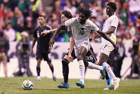 Ghana's Emmanuel Edjei (18) and Mexico's Brian Gutiérrez vie for the ball during an international friendly soccer match in Puebla, Mexico.