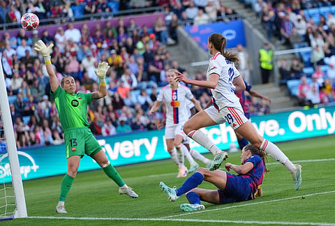 Lyonnes' Jule Brand has a shot on goal blocked by Barcelona's Irene Paredes, on the ground, during the Women's Champions League final soccer match between FC Barcelona and OL Lyonnes, in Oslo.