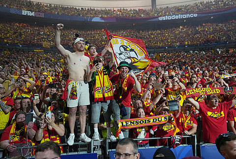Lens supporters celebrate after their team won the French Cup soccer final between Nice and Lens in Saint-Denis, outside Paris.