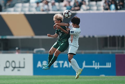 Tokyo Verdy Beleza's Rihona Ujihara, left, battles for the ball against Naegohyang Women's FC's Ri Myong Gum during the AFC Women's Champions League soccer final match in Suwon, South Korea.