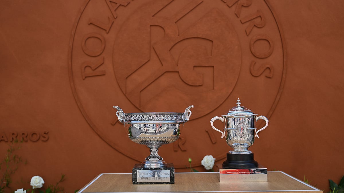 The men's, left, and women's trophies are displayed in-front of the Roland-Garros logo during qualifications for the French Open tennis tournament in Paris, Friday. - AP