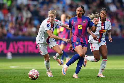 Lyonnes' Ada Hegerberg, from left, Barcelona's Salma Paralluelo and Lyonnes' Ashley Lawrence eye the ball during the Women's Champions League final soccer match between FC Barcelona and OL Lyonnes, in Oslo.