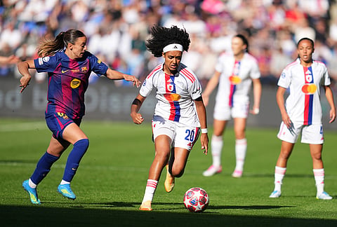 Barcelona's Clara Serrajordi, left, vies for the ball with Lyonnes' Lily Yohannes during the Women's Champions League final soccer match between FC Barcelona and OL Lyonnes, in Oslo.
